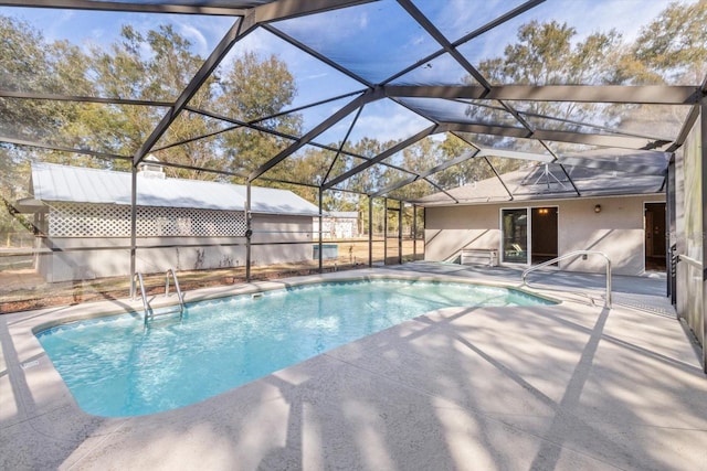 view of pool featuring a patio area and glass enclosure