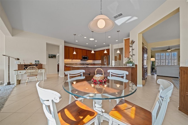 dining area featuring ceiling fan and light tile patterned floors