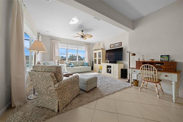 tiled living room featuring ceiling fan