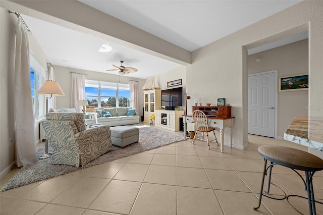 living room featuring ceiling fan and light tile patterned floors