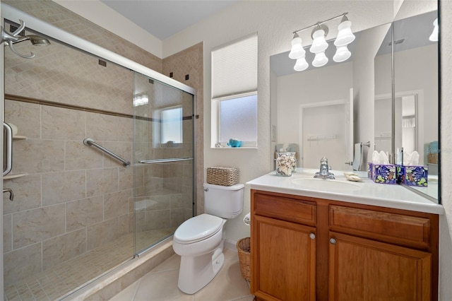 bathroom featuring vanity, toilet, an enclosed shower, and tile patterned flooring