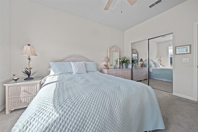 bedroom featuring light carpet, ceiling fan, and a closet