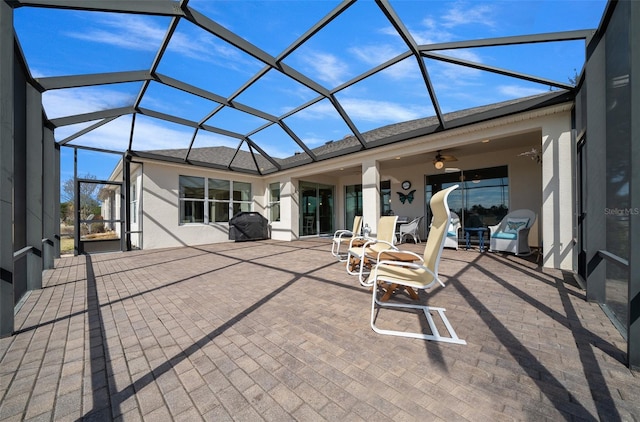 view of patio featuring a lanai and ceiling fan