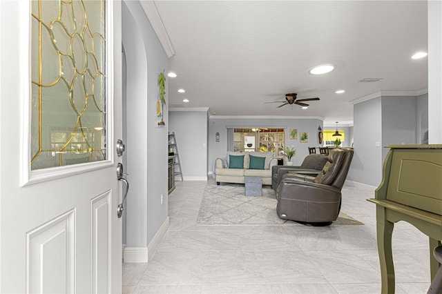 foyer entrance with crown molding, a textured ceiling, and ceiling fan