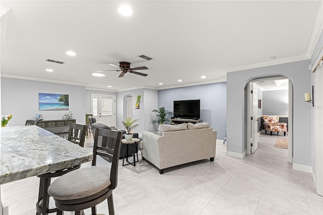 living room with crown molding and ceiling fan