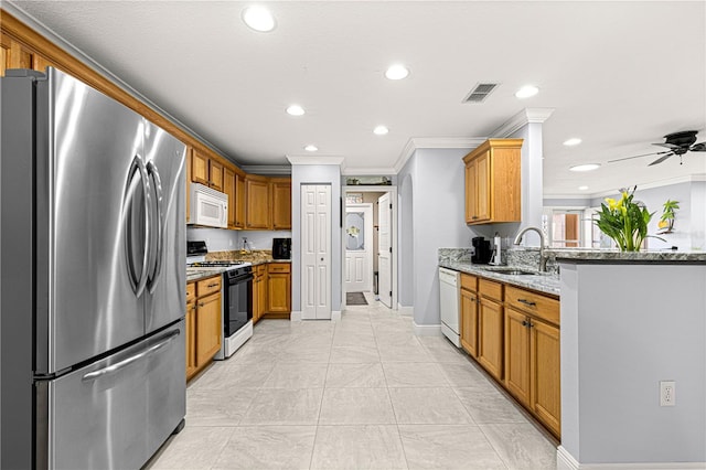 kitchen with white appliances, ornamental molding, light stone countertops, and sink