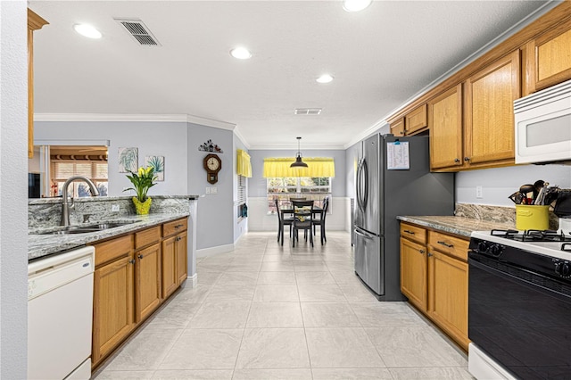 kitchen featuring sink, crown molding, pendant lighting, white appliances, and light stone countertops