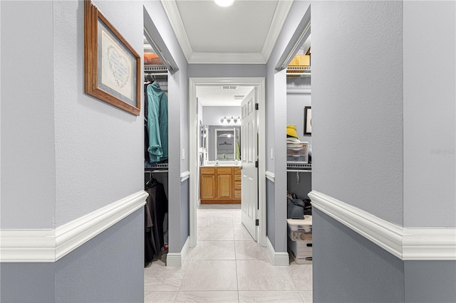 hallway featuring crown molding and sink