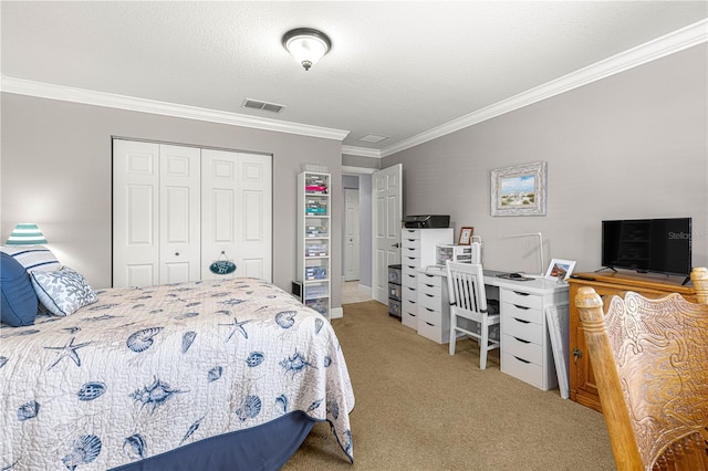 bedroom with a closet, ornamental molding, carpet, and a textured ceiling