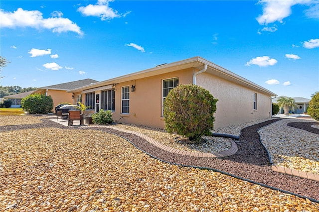 rear view of property featuring a patio