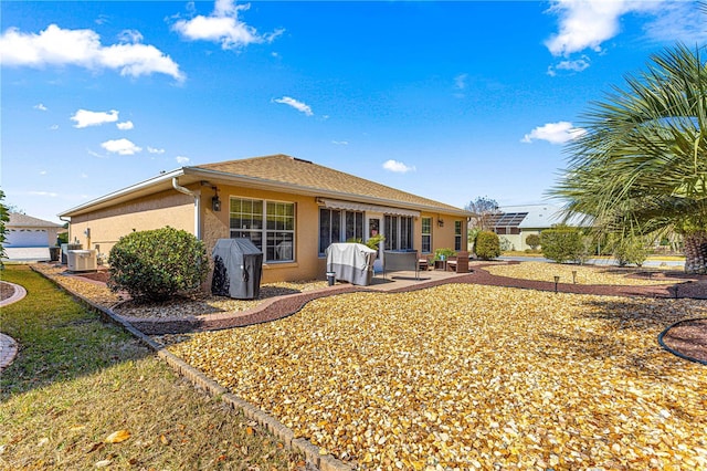 rear view of house featuring a patio and central AC unit