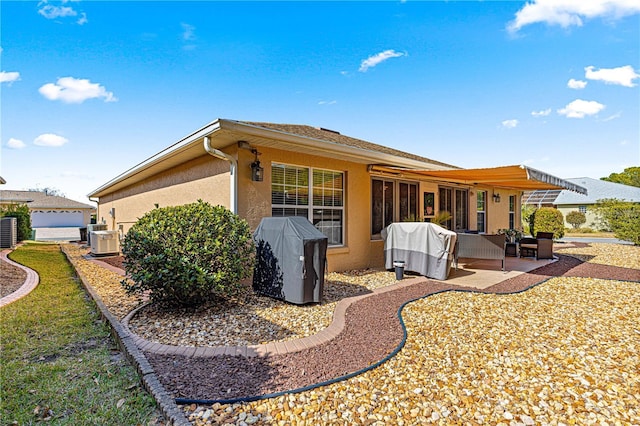 rear view of property featuring central AC unit, ac unit, and a patio area