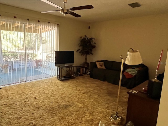 unfurnished living room featuring ceiling fan and carpet floors