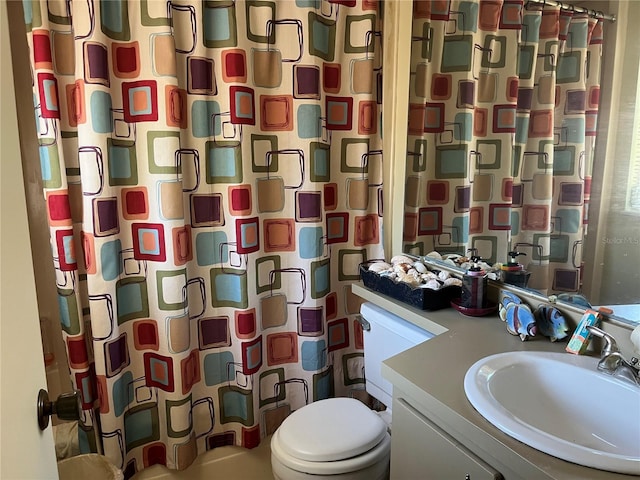 bathroom with vanity, toilet, and a shower with shower curtain