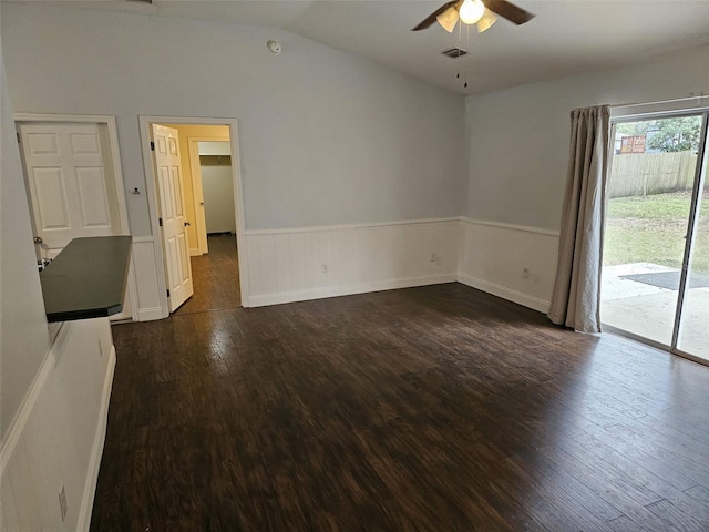 spare room with lofted ceiling, dark hardwood / wood-style flooring, and ceiling fan