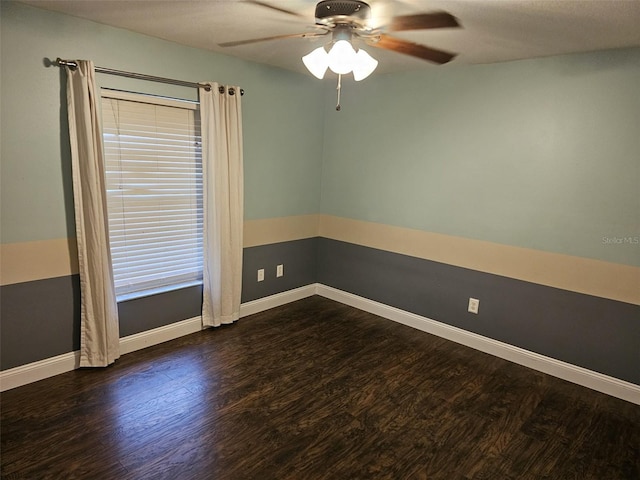 spare room with ceiling fan and dark hardwood / wood-style flooring