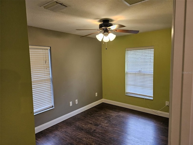 unfurnished room featuring a textured ceiling, dark wood-type flooring, and ceiling fan