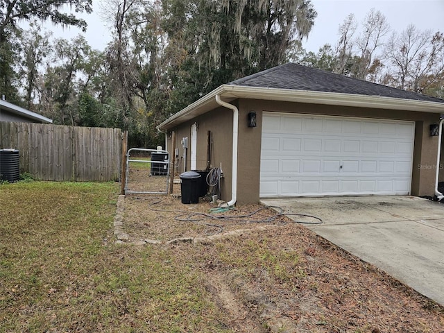 view of side of property with an outbuilding, a yard, a garage, and central air condition unit