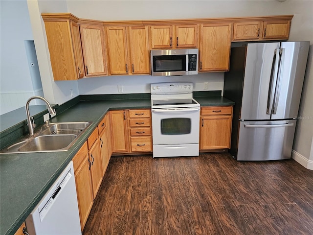 kitchen with dark wood-type flooring, appliances with stainless steel finishes, and sink