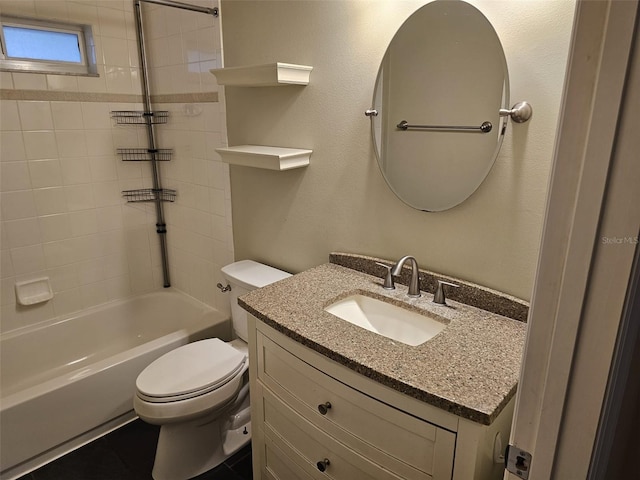 full bathroom with vanity, tiled shower / bath combo, and toilet