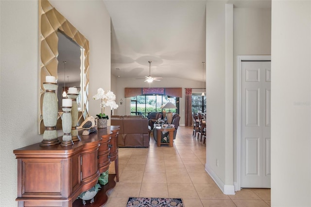 hallway featuring lofted ceiling and light tile patterned floors