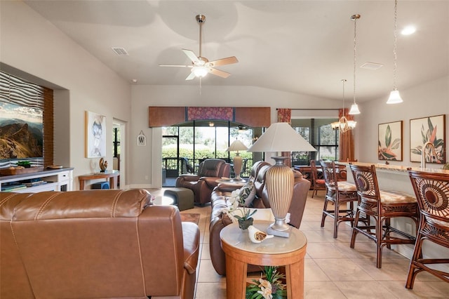 living room with ceiling fan with notable chandelier, vaulted ceiling, and light tile patterned flooring