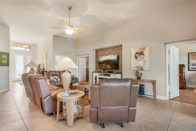 living room featuring light tile patterned floors and ceiling fan