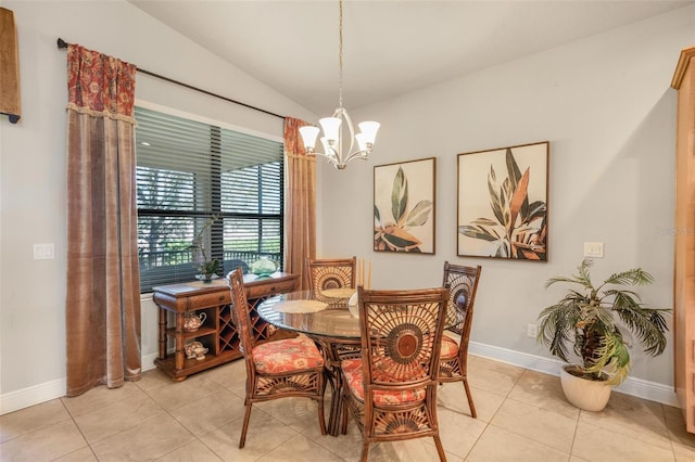 tiled dining area with lofted ceiling and a chandelier