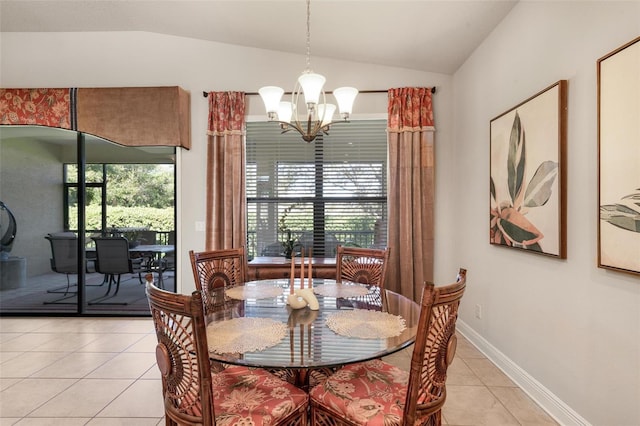 dining room featuring light tile patterned flooring, lofted ceiling, and an inviting chandelier