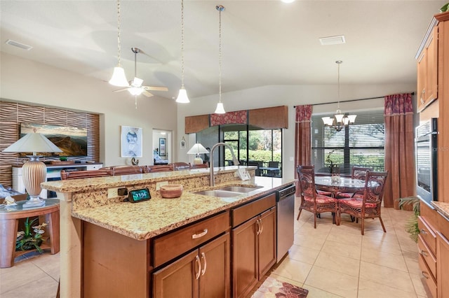 kitchen with vaulted ceiling, pendant lighting, sink, stainless steel appliances, and a center island with sink