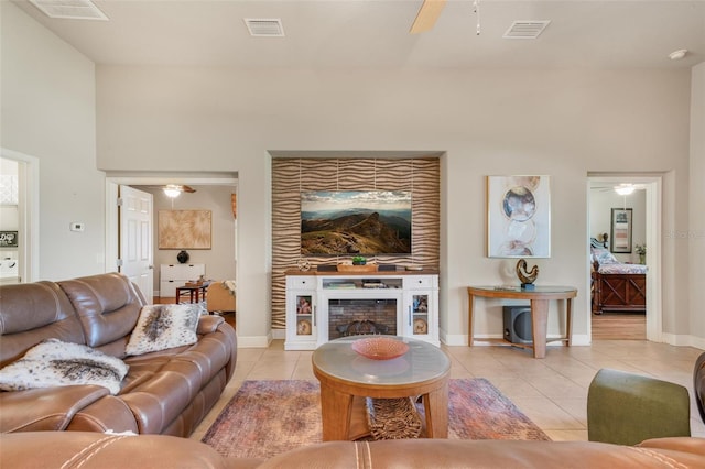 living room featuring ceiling fan and light tile patterned flooring