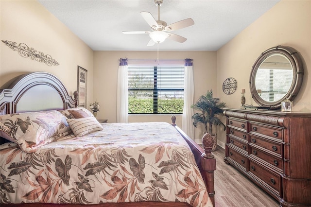 bedroom featuring a textured ceiling, ceiling fan, and light hardwood / wood-style flooring