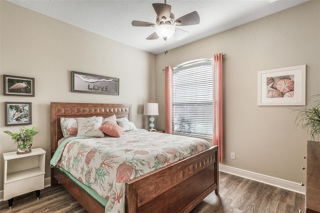 bedroom with a textured ceiling, dark hardwood / wood-style floors, and ceiling fan