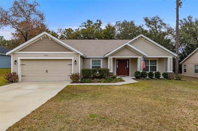 view of front of home with a garage and a front lawn