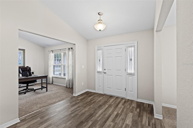 foyer entrance featuring vaulted ceiling and dark wood-type flooring