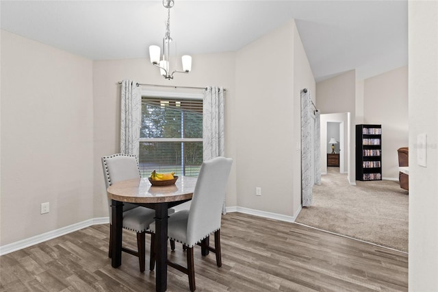 dining room featuring hardwood / wood-style floors and an inviting chandelier