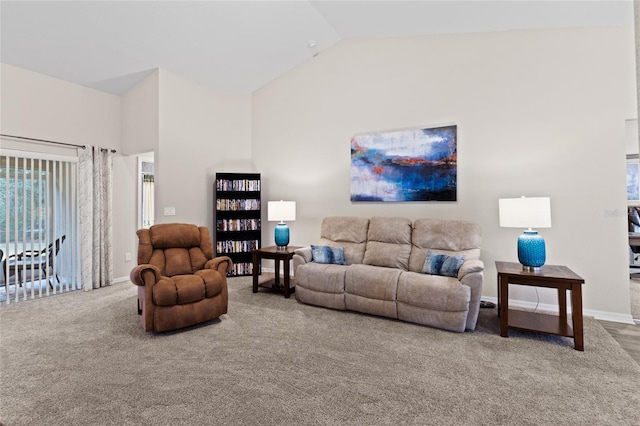 living room featuring carpet floors and vaulted ceiling