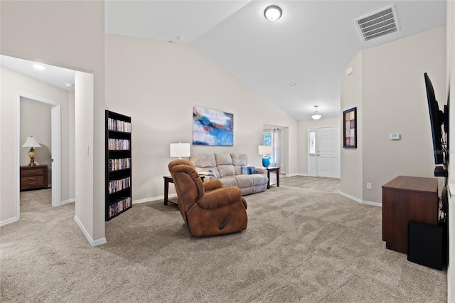 carpeted living room featuring lofted ceiling