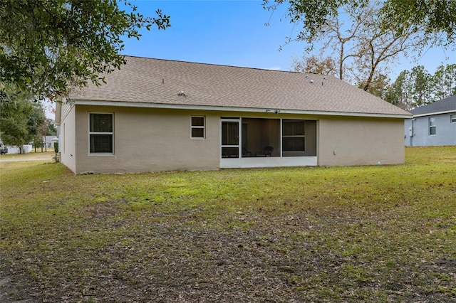 rear view of property with a yard