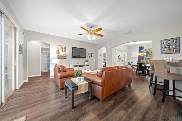 living room featuring dark hardwood / wood-style floors and ceiling fan