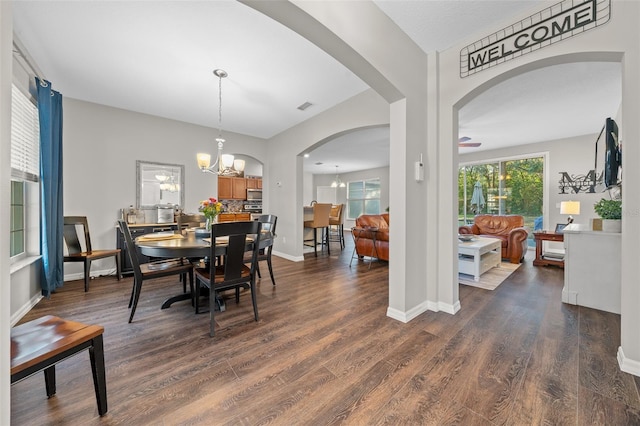 dining room featuring dark hardwood / wood-style flooring and a notable chandelier