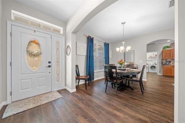 entryway with a notable chandelier and dark hardwood / wood-style floors