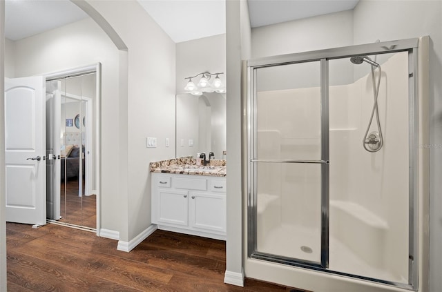 bathroom with vanity, hardwood / wood-style floors, and walk in shower