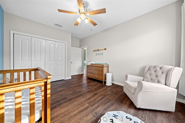 bedroom with ceiling fan, dark hardwood / wood-style flooring, and a closet