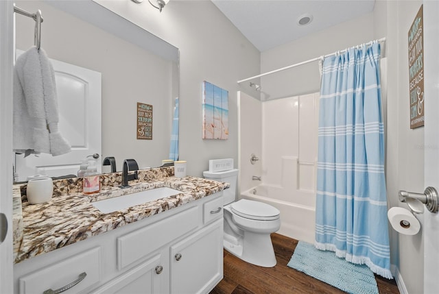 full bathroom featuring wood-type flooring, shower / bath combo, vanity, and toilet