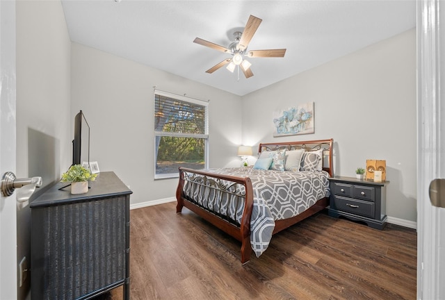 bedroom with dark hardwood / wood-style floors and ceiling fan