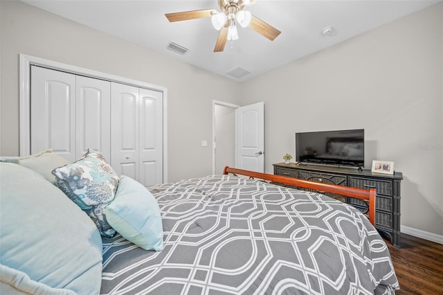 bedroom with ceiling fan, dark hardwood / wood-style flooring, and a closet