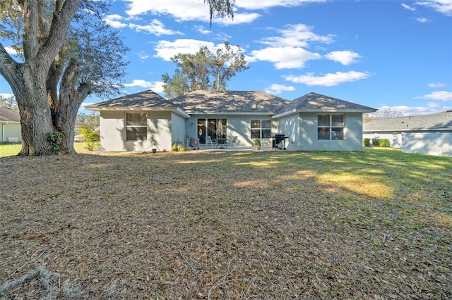 back of property featuring a yard and a patio area