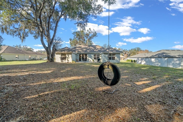 back of house with a lawn