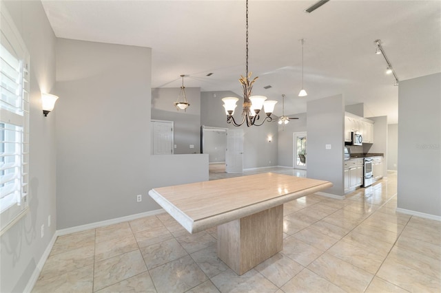 kitchen featuring white cabinetry, vaulted ceiling, hanging light fixtures, a kitchen island, and stainless steel appliances